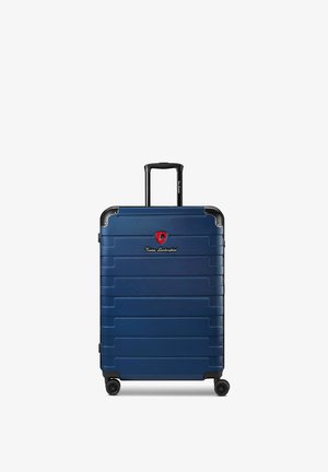 Valise rigide bleu marine avec poignée télescopique, quatre roues et logo Tonino Lamborghini sur le devant.
