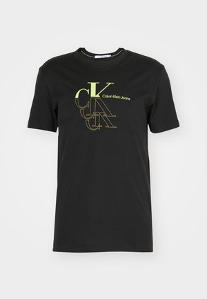 Sort bomuld T-shirt med korte ærmer, der har et flerfarvet "Calvin Klein Jeans"-logo i limegrøn og guld foran.