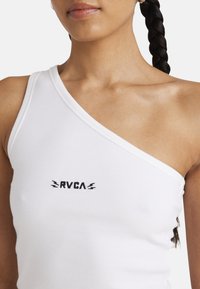 White ribbed tank top with one shoulder strap; features black RVCA logo below the neckline. Soft texture and fitted design.