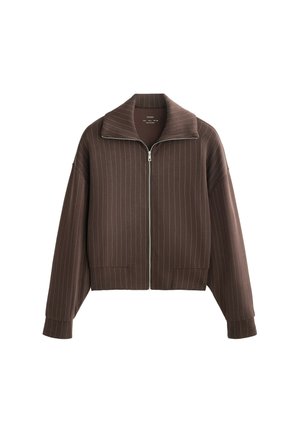 Jachetă crem cu fermoar, cu guler lat și mâneci lungi, având dungi verticale și un design scurt. Material moale cu o textură netedă.