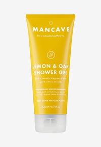 Tube jaune de gel douche Mancave au citron et au chêne, 200 ml. Présente un texte blanc et une icône de feuille de chêne. Possède une base transparente et un bouchon à vis.