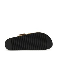 Black rubber sandal sole with a ridged texture. Features a rounded toe and an ergonomic design for comfort and grip.