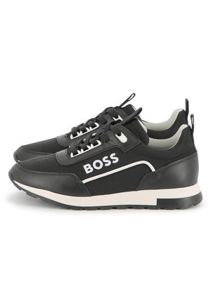 Black sneakers with a mix of smooth leather and textile materials. Features a white logo and accents, lace-up design, and rubber sole.