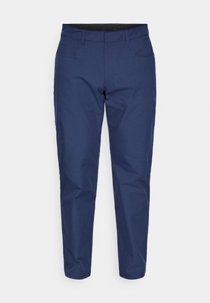 Temno modre hlače iz gladkega blaga, z zadrgo, zankami za pas in več žepi, krojene z ozkimi hlačnicami.