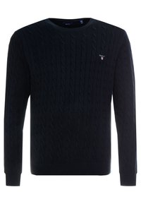 Navy blauwe kabelgebreide trui met een ronde hals en ribgebreide manchetten. Klein geborduurd logo op de borst, gemaakt van zachte stof.