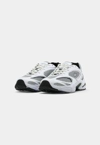 White athletic shoes with mesh panels, cushioned soles, and black accents; featuring a rounded toe and lace-up design.