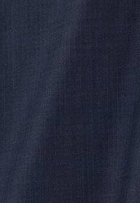 Tissu bleu foncé avec un motif chevron subtil et une texture de tissage diagonal fine visible.