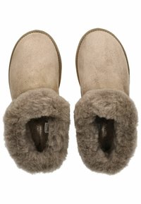 Beige suede slippers with a soft, thick brown fur lining. Round shape with a cushioned sole. Features minimal stitching along the edges.