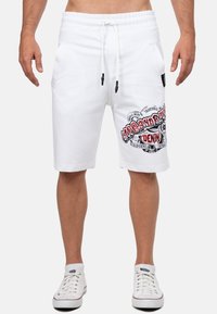 Witte katoenen shorts met een elastische tailleband, voorzien van zijzakken en een grafische print in zwart en rood op de linkerdij.