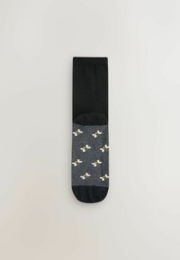Zwarte en grijze sokken met een bijpatroon op het grijze gedeelte, met een gladde textuur en een contrasterende effen zwarte bovenkant.