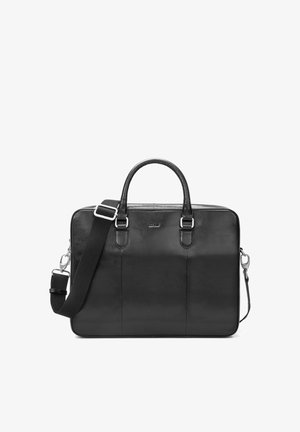 Czarna skórzana teczka z podwójnymi uchwytami oraz regulowanym, odpinanym paskiem na ramię, przedstawiona na białym tle.