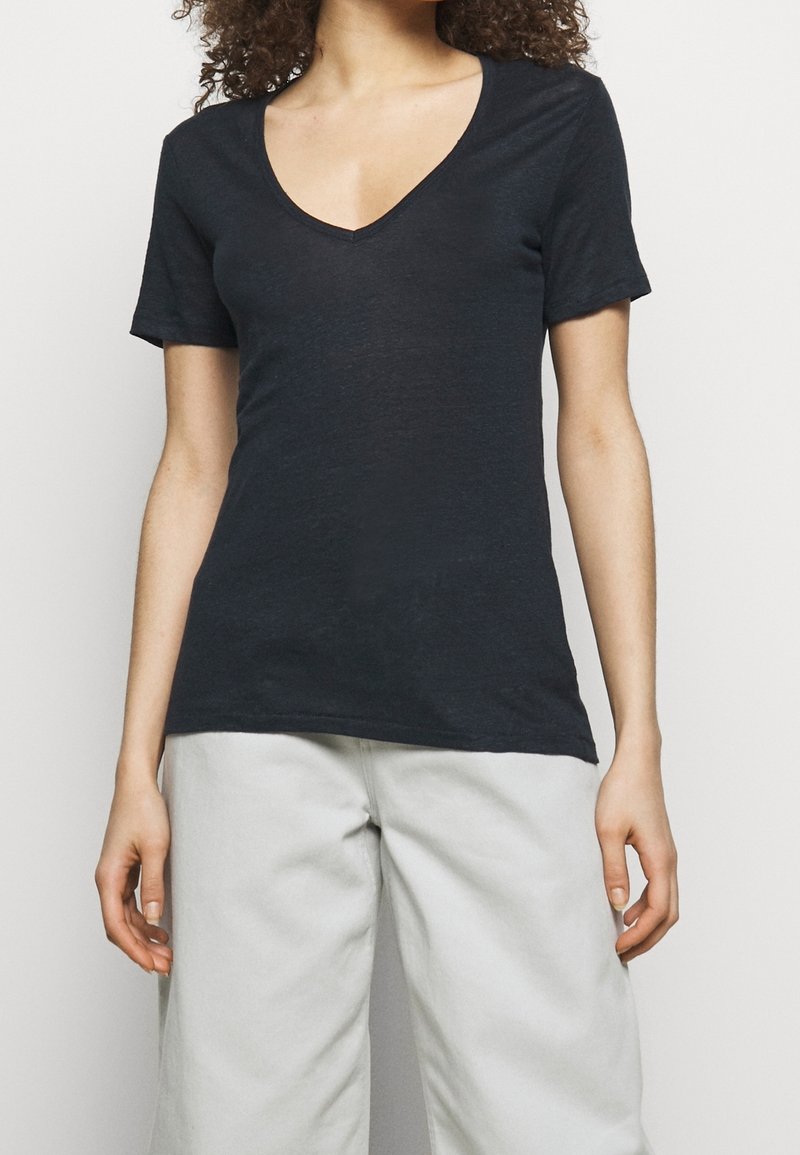 Black short-sleeved V-neck t-shirt with a soft texture, featuring a fitted design and a slightly loose fit at the waist.