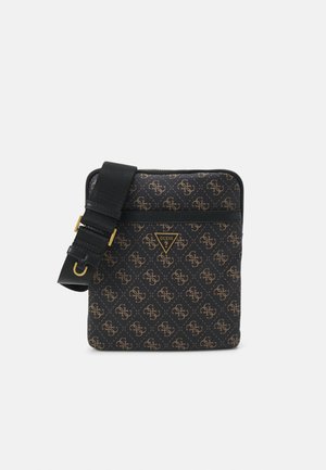 Black crossbody bag with brown monogram pattern, adjustable strap, and gold Guess logo on the front.