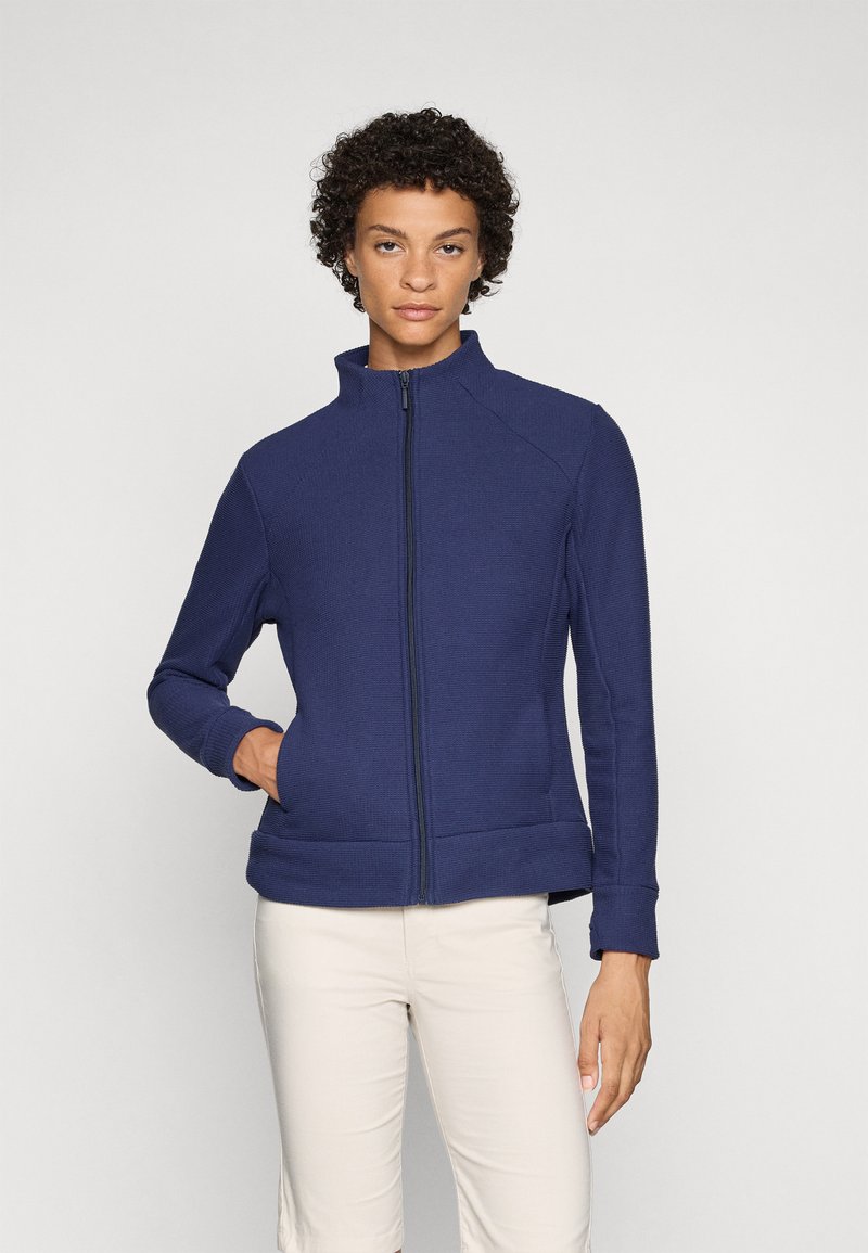 Tumed zip-up jope ribbed tekstuuriga, kõrge kaelusega ja kahe küljetaskuga. Tootes on sobivad mansetid ja places, mis on loodud voolujoonelise välimuse saavutamiseks.