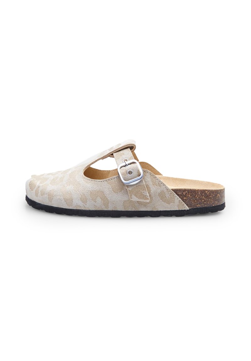 Suede slip-on shoe in light beige with leopard print pattern, featuring a strap with a silver buckle and a cork footbed. Rounded toe, black sole.