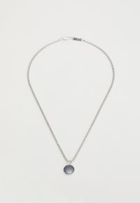 Collier en argent comprenant un pendentif rond avec un motif de rayons de soleil texturé. La chaîne est délicate et au design épuré.