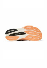 Running shoe sole with a black and white design, orange rubber traction patterns, and a visible "ENERGY ARC" branding detail.