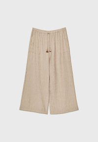 Pantalon large en lin beige clair avec taille élastique et cordons à pompons, poches avant, et coupe décontractée.