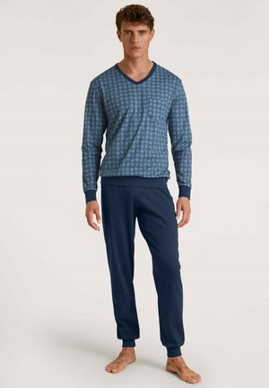 Marineblaues Lounge-Set bestehend aus einem gemusterten Langarmshirt mit V-Ausschnitt und passender Hose mit gerippten Bündchen, aus weichem Material gefertigt.