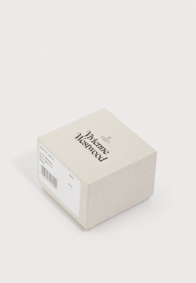 Μικρό μπεζ κουτί Vivienne Westwood με λευκή ετικέτα που δείχνει λεπτομέρειες προϊόντος και γραμμωτό κώδικα σε λευκό φόντο.