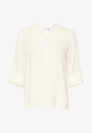 Blouse blanche en tissu léger et texturé. Présente un décolleté en V, une patte de boutonnage à trois boutons et des manches retroussées avec des accents de boutons.