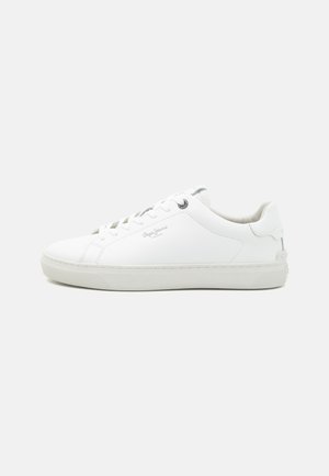 Valge tennis shoe sileda nahkpealisega, paeltega sulgemisega, kummist tallaga ja diskreetse brändinguga külgedel. Minimalistlik disain ja ümar varvas.