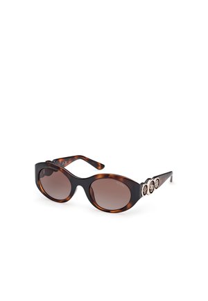 Tortoiseshell sunglasses with oval lenses, brown gradient tint, wide frames, and decorative gold-tone accents on the temple.