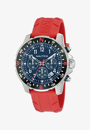 Nautica käekell tumesinise sihverplaadi, punase silikoonist rihma, hõbedase roostevabast terasest korpuse ja musta raammiga. Kellal on kronograafi funktsioonid ja kuupäeva näidik.