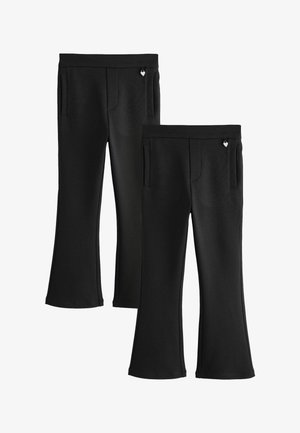 Deux paires de pantalons noirs évasés avec poches latérales et tirettes de fermeture éclair en forme de cœur sur fond blanc.