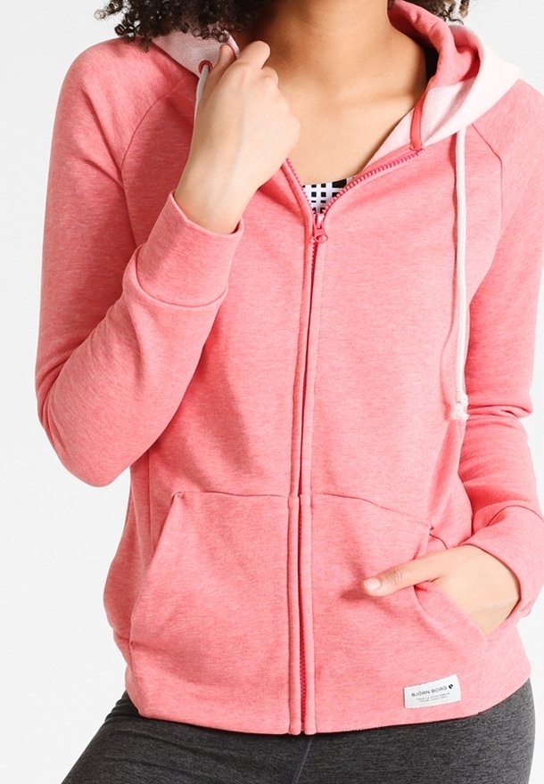Sweat à capuche zippé rose en tissu doux, avec une capuche doublée, des cordons de serrage, des poches avant et une petite étiquette logo sur l'ourlet.