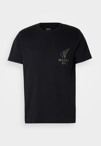 Black t-shirt made of cotton, featuring a green graphic logo on the left chest. It has a crew neckline and short sleeves.