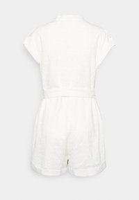 White lace short-sleeve romper with collar, belted waist, and cuffed shorts viewed from the back against a plain background.