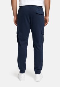 Marineblaue Cargo-Hosen aus weichem Material, mit Seitentaschen, elastischen Bündchen und einem bequemen Bund. Geeignet für die Freizeit.