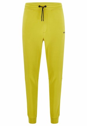 Pantalon de jogging slim jaune avec cordon noir et petit logo "BOSS" sur la cuisse supérieure, poignets élastiques aux chevilles.