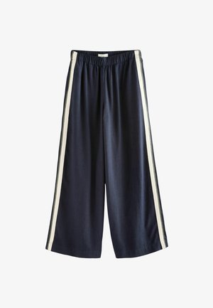 Marineblaue weite Hosen mit elastischem Bund, die kontrastierende cremefarbene Seitenstreifen und eine glatte Textur aufweisen.