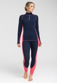 Marine termisk sæt med lyserøde sidepaneler. Toppen har en høj krave og kvart lynlås, mens leggings har en tætsiddende design og ankelmanchetter.