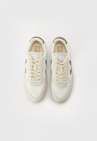 White mesh sneakers with beige accents, round toe, flat laces, and textured surface. Featuring a light-colored rubber sole and logo on tongue.