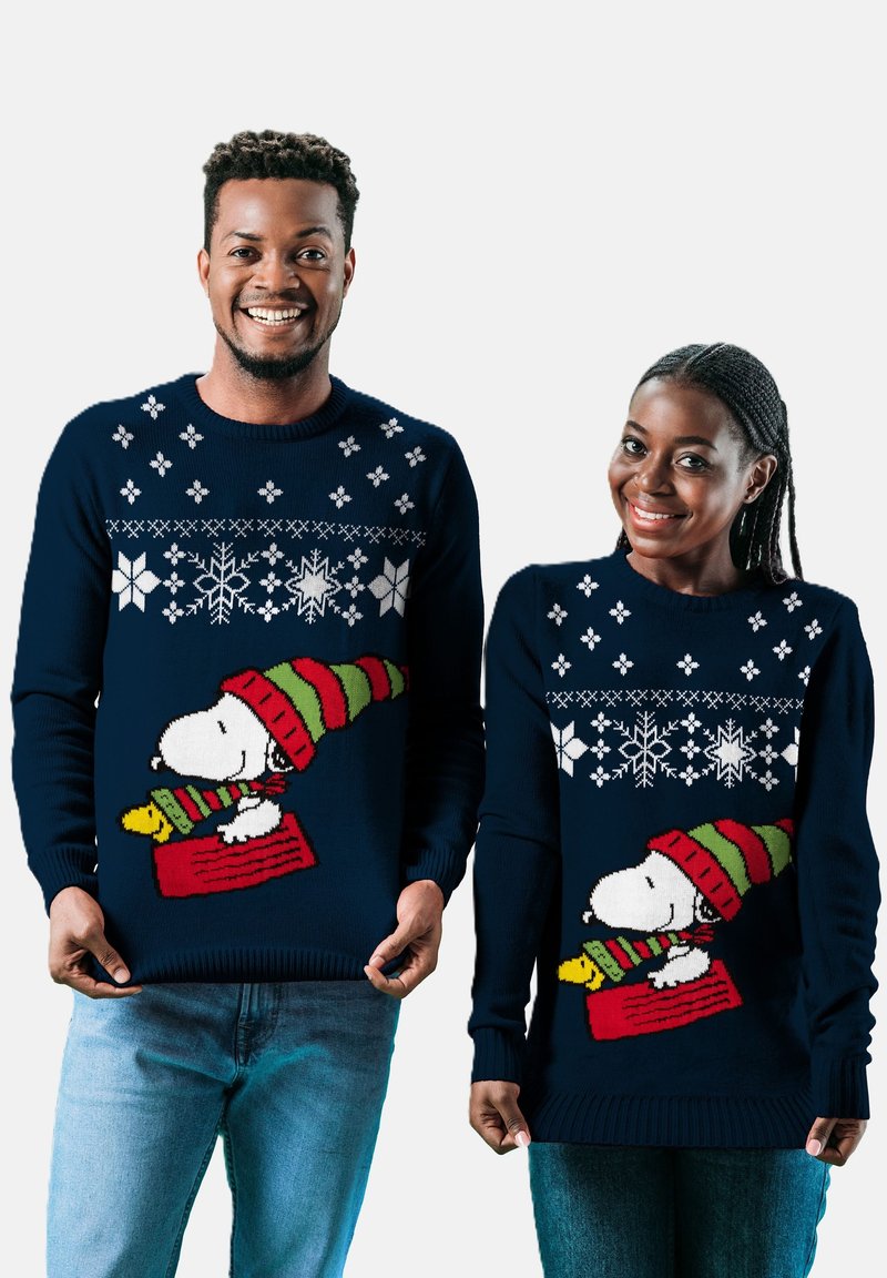Navy blue knit sweaters featuring white snowflakes and Snoopy in a festive hat. The design includes red and green striped accents.