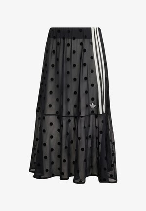 Gonna midi nera trasparente con pois in velluto, strisce laterali bianche, fascia elastica in vita e piccolo logo Adidas vicino all'orlo.
