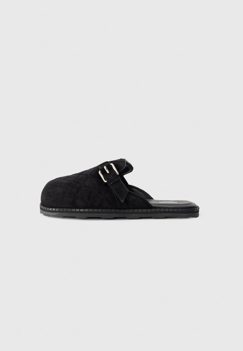 Black quilted slide sandal featuring a lightweight design, adjustable strap with buckle, and textured sole for enhanced grip.
