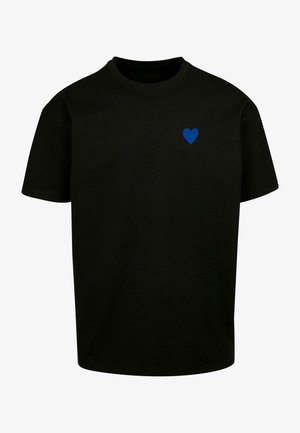 Black cotton T-shirt with short sleeves, featuring a small blue heart graphic on the left chest. Round neckline, relaxed fit.