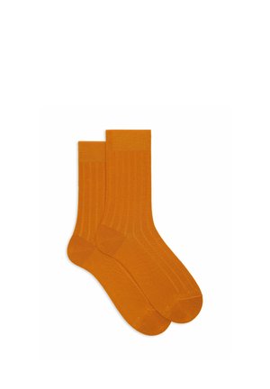 Calzini arancioni a coste con una texture liscia, caratterizzati da un design classico a metà polpaccio e da un morbido polsino a contrasto in cima.