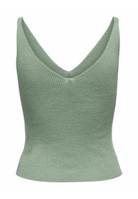 Top a maniche senza maniche verde lavorato a maglia con scollo a V profondo, texture a coste e silhouette aderente. Il tessuto appare morbido ed elastico.