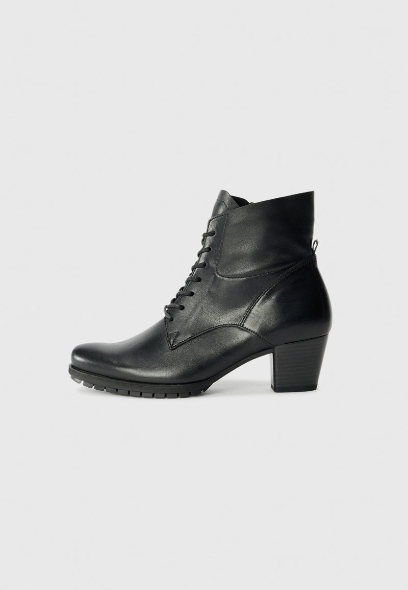 Bottine en cuir noir avec un bout rond, un système de laçage et un talon épais ; présente une texture lisse et des détails de couture subtils.