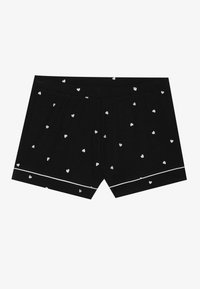 Sorte boxershorts laget av myk stoff, med et mønster av små hvite hjerter og et hvitt kantbånd langs bunnen.