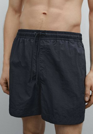 Dunkelgraue Badeshorts aus leichtem Material, mit elastischem Bund, Kordelzug und lässiger Passform.