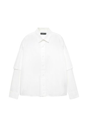 Chemise blanche à manches longues en coton avec un devant boutonné, dotée d'un col classique et de manches oversized avec une coupe décontractée.