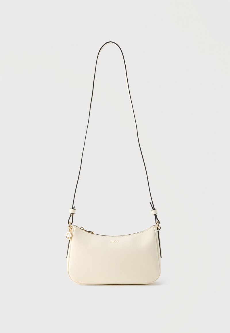 Μικρό κρεμ δερμάτινο τσαντάκι ώμου με λεπτό μαύρο λουράκι, χρυστό φερμουάρ και μικρό χρυσό λογότυπο BOSS μπροστά.