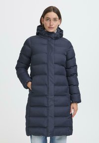 Navy puffer coat featuring a hood, long sleeves, vertical quilting, and a knee-length design with side pockets. Soft, smooth texture.