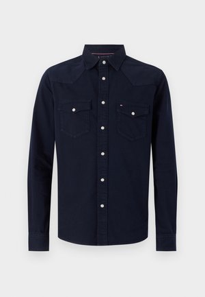 Navy cotton long-sleeve shirt with snap buttons, two chest pockets, and contrasting stitching. Features a pointed collar and western-style yokes.